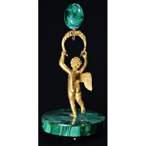 5112 - A Continental gilt bronze and malachite figural pocket watch stand, as a putto, circular base, ball ... 