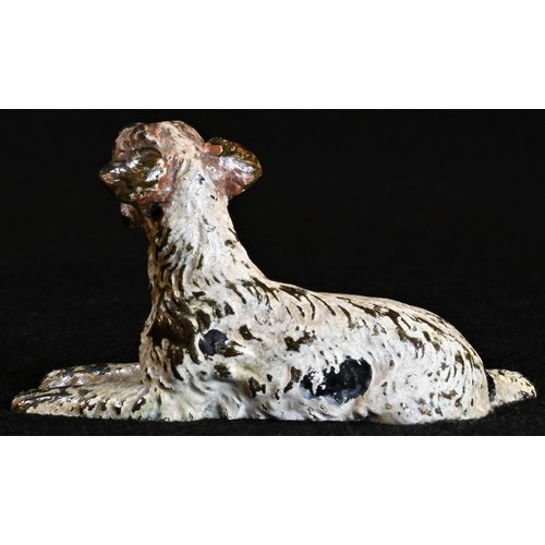 5317 - An Austrian cold painted bronze, of a recumbent terrier dog, 5cm long, Vienna, c.1900