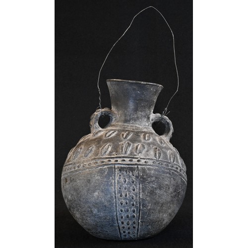 5763 - Tribal Art - an African black earthenware amphora-shaped vessel, the globular body with pinched lugs... 