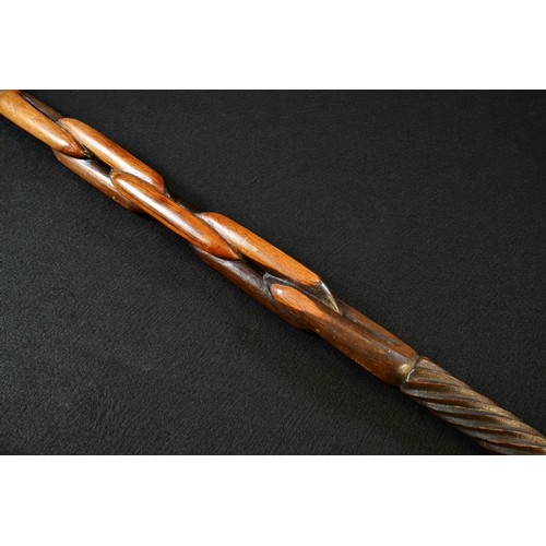 5762 - Tribal Art - a Zulu hardwood prestige staff, globular 'knobkerrie' pommel, the shaft carved with spi... 