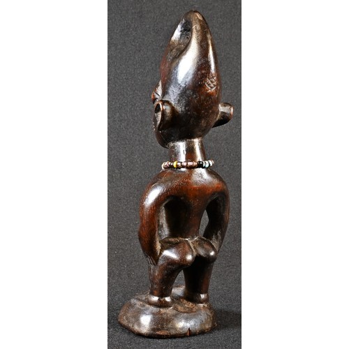 5761 - Tribal Art - a Yoruba Ibeji figure, standing with arms to the side, adorned with a beadwork necklace... 