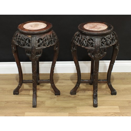 1515 - A pair of Chinese hardwood jardinière stands, circular tops with inset soapstone panels, pierced and... 