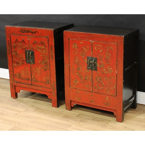 1517 - A pair of Chinese red lacquer side cabinets, each with a pair of doors, decorated with monumental la... 