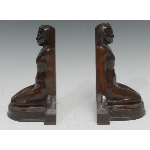 1504 - A pair of 19th century bronze bookends, cast as kneeling Egyptian ladies, 19cm hihg, retailed by The... 