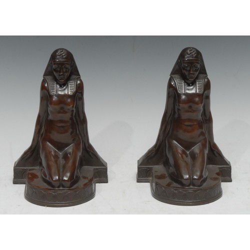 1504 - A pair of 19th century bronze bookends, cast as kneeling Egyptian ladies, 19cm hihg, retailed by The... 