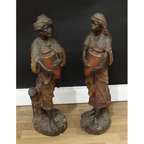 1511 - A pair of Austrian Orientalist terracotta figures, modeled as Nubian water carriers, each exotically... 