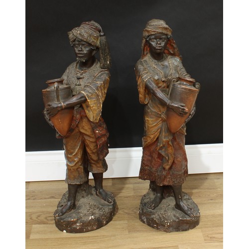 1511 - A pair of Austrian Orientalist terracotta figures, modeled as Nubian water carriers, each exotically... 