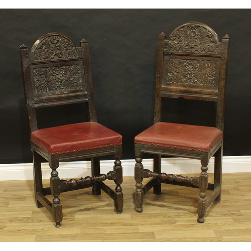 1501 - A near pair of 17th/early 18th century oak back stools, arched panel backs flanked by pyramidal fini... 