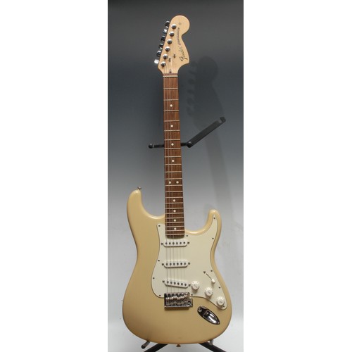 1498 - A Fender Stratocaster electric guitar, USA honey blonde, maple neck, rosewood finger board. Serial n... 