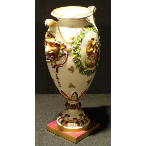 15 - A Continental porcelain ovoid pedestal vase, 31cm high