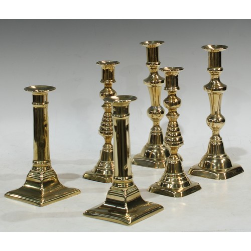 81 - A pair of brass ejector candlesticks, 19th century, 22.5cm; two other pairs smaller (6)