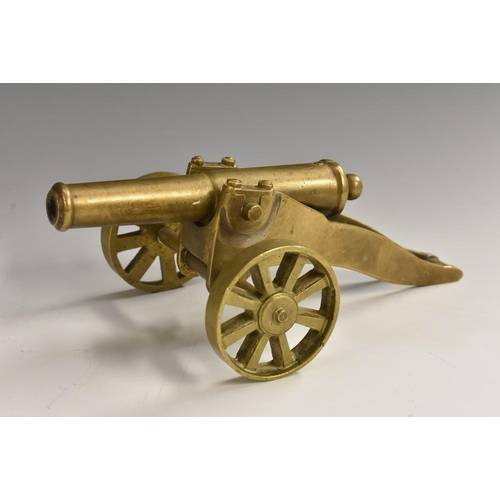 3089 - An early 20th century cast brass desk model signal cannon, 11.5cm barrel with touch-hole, the carria... 