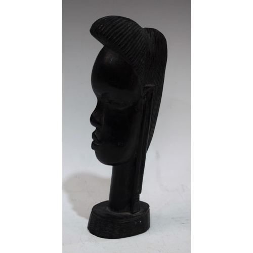 24 - Tribal Art - a carved hardwood African bust, 23.5cm high