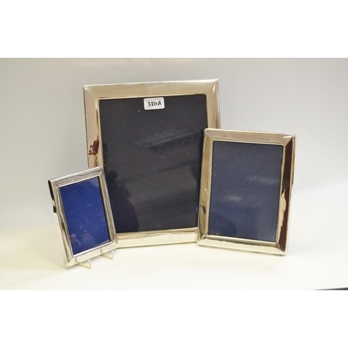 380A - A substantial silver photograph frame; a near pair of EPNS frames (3)