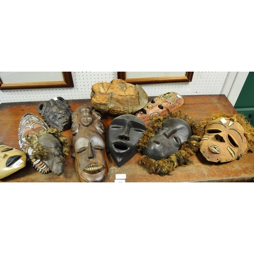 417 - Tribal Art - six African masks including a carved ebony example; a carved coconut husk in form of  f... 