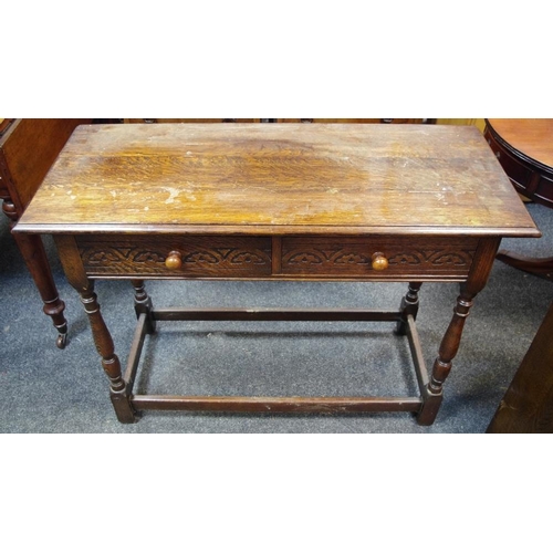 451 - An oak hall table, moulded top, two short blind fretworked drawers to frieze, button handles, turned... 