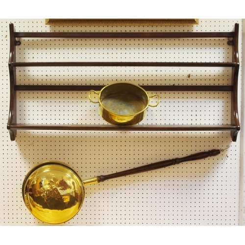 466 - An Ercol wall mounted plate rack; a brass warming pan and two handled pan. (3)