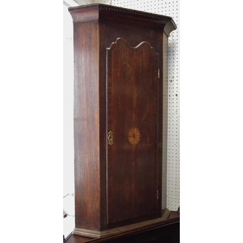 468 - A oak wall mounted corner cabinet of small proportions, outswept cornice, canted angles, shaped door... 