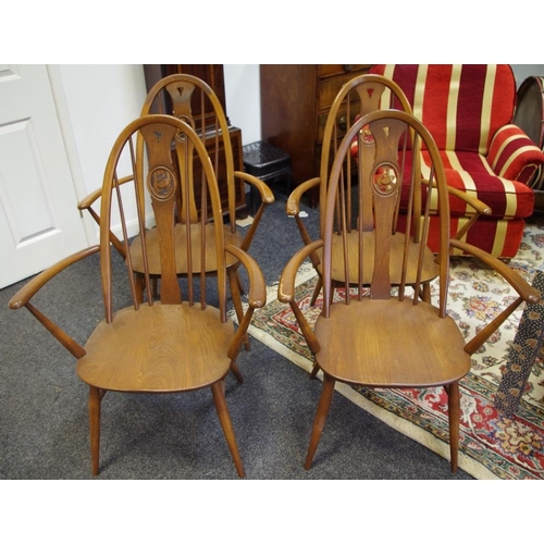 496 - Four Ercol swan back carver chairs