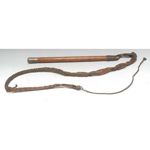 3210 - A late 19th century Colonial hardwood and leather whip, silvered pommel inscribed H E Dumbell, Gibra... 