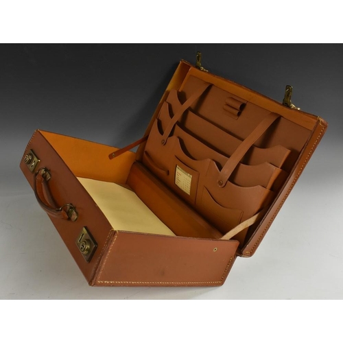 3227 - A mid-20th century gentleman's tan leather brief case, hinged cover, the fitted interior with calend... 