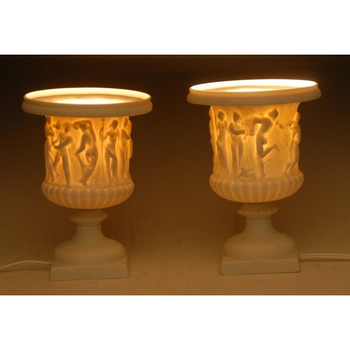 3279 - A pair of Limoges parian ware 'lithophane' table lamps, each as a Grand Tour, vase modelled after th... 