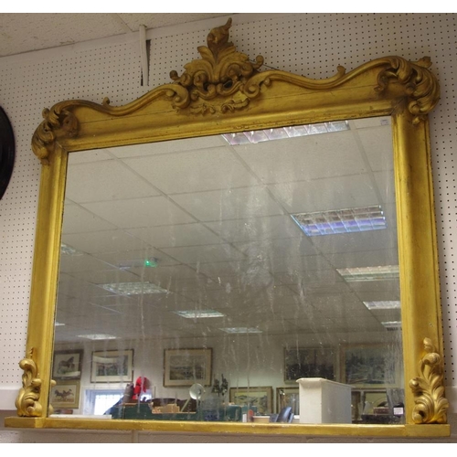 103 - ***Flood damaged***A large giltwood overmantel looking glass, rectangular mirror plate framed with a... 