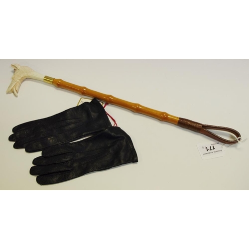 12 - A child's reproduction hunt whip, moulded hound head; a pair of child's leather gloves (2)