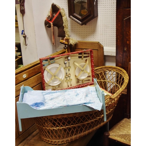 122 - A 1960's Countryman picnic hamper, a hobby horse, a doll's bed, a wicker cradle