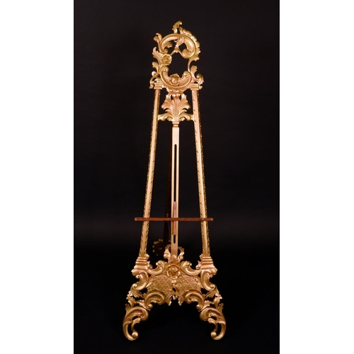 3303 - A Rococo gilt softwood picture easel, acanthus-capped leafy C-scroll cresting, laureate stratchers, ... 