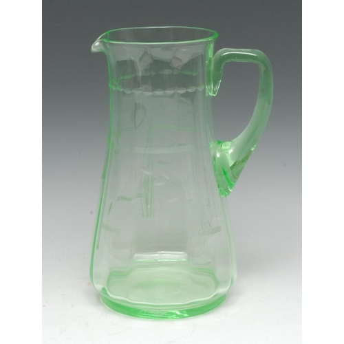 3421 - An early 20th century uranium glass water jug, lightly fluted and engraved with leafy stems and Art ... 