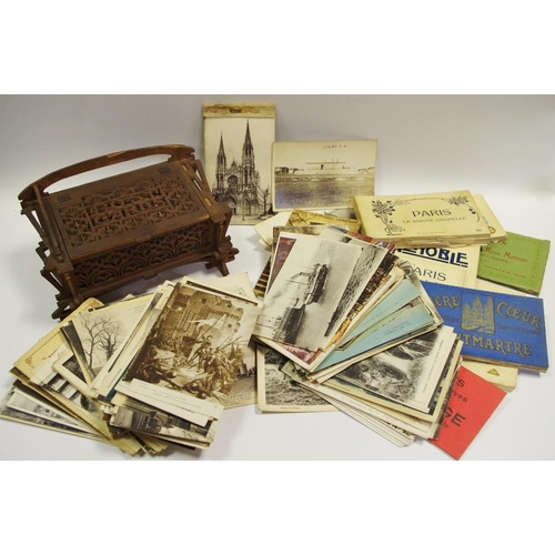 345 - Postcards - an early 20th century postcard box, Arts and Crafts carvings; Militaria postcards; embro... 