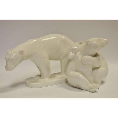 36 - A KPM porcelain model of a walking polar bear, printed marks to base; another KPM model of playing p... 