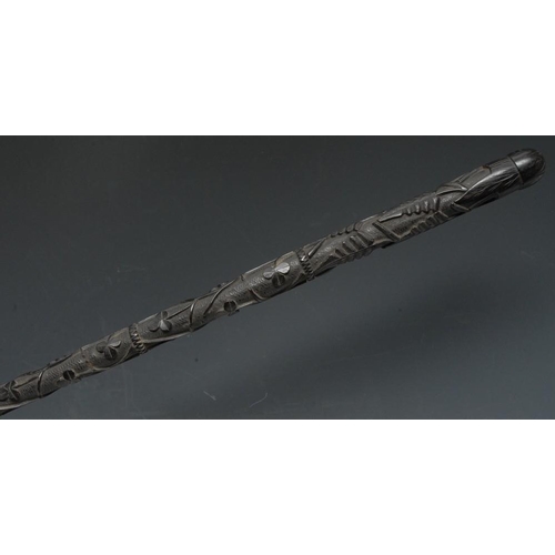 3594 - A 19th century Irish bog oak walking stick, carved in relief with shamrocks and ferns, 88cm long