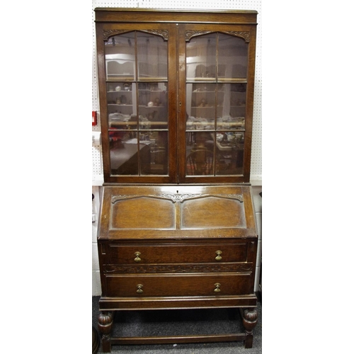 421 - An early 20th century oak bureau bookcase