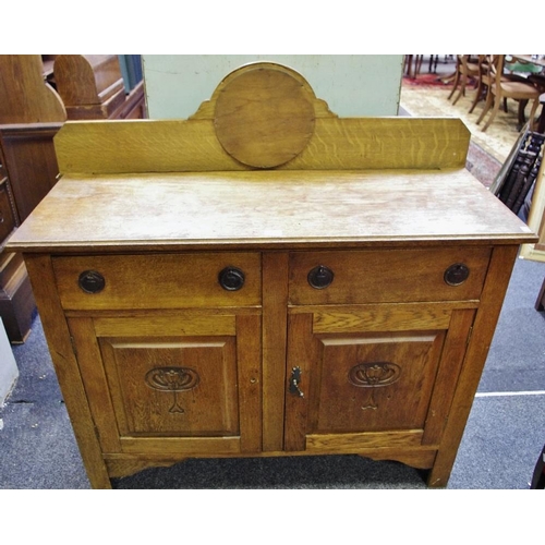 427 - An Arts & Crafts oak sideboard, stylized tulip carved panel doors, c.1920