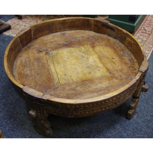 435 - An Indian hardwood corn table, circular top, heavily carved throughout