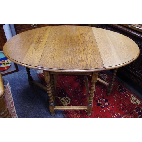 444 - An early 20th century oak barley twist drop leaf dining table