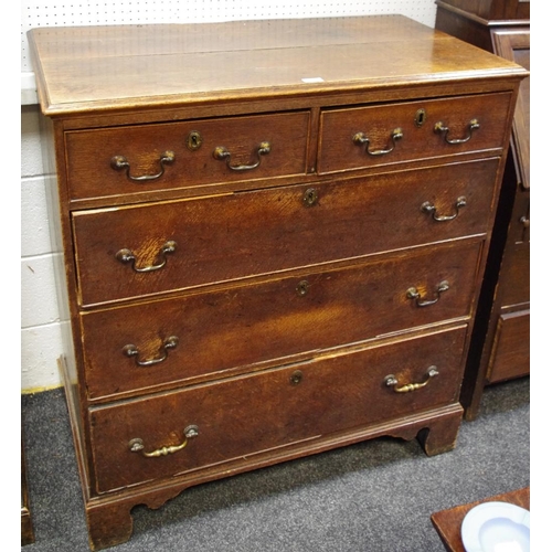 458 - A George III oak chest, two short drawers over three graduated long, brass swan neck handles, ogee f... 