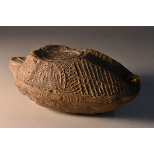 3757 - Antiquities - an ancient Middle-Eastern terracotta oil lamp, naively moulded in shallow relief as a ... 