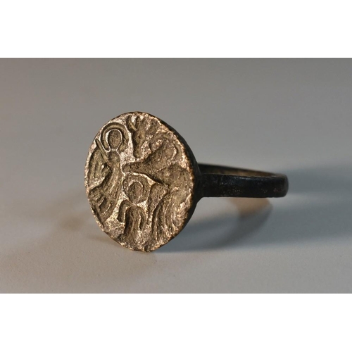 3758 - Antiquities - an Anglo-Saxon dark-patinated bronze ring, the 1.7cm diam circular matrix in relief wi... 