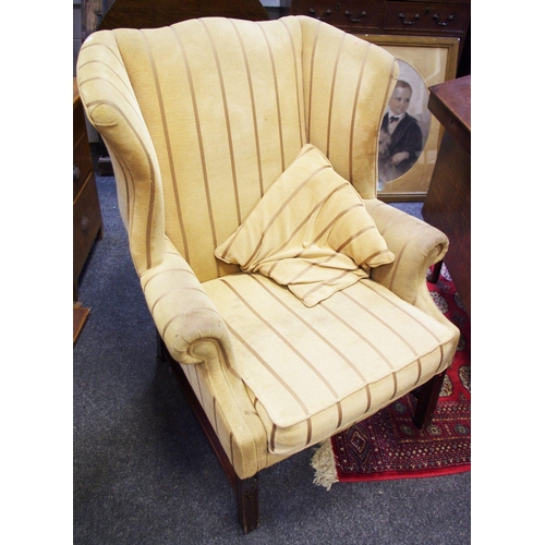 532 - A wingback armchair, mahogany frame, pin striped upholstery