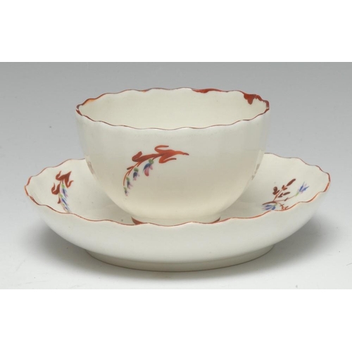 107 - A Pinxton straight-fluted tea bowl and saucer, pattern 1, red sprig version, iron red borders, the t... 