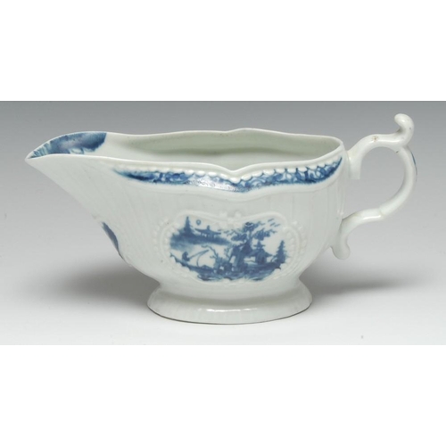 116 - A  Worcester Fisherman and Billboard Island pattern strap fluted sauce boat, painted in blue with tw... 