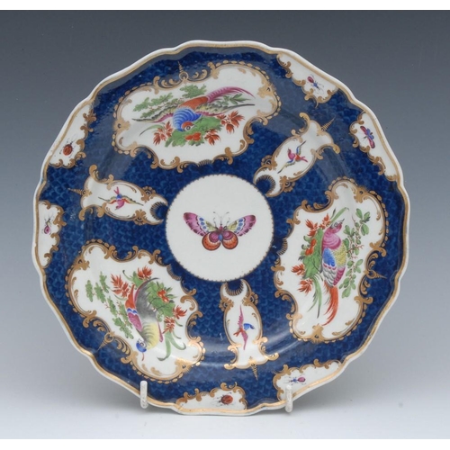 117 - A  Worcester shaped circular plate, decorated with fan and vase shaped reserves with fanciful birds ... 