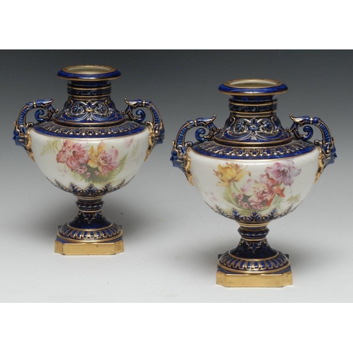 132 - A pair of Royal Worcester two-handled vases, painted with country flowers in bloom on a white ground... 