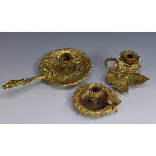 1456 - A post-Regency gilt metal chamber stick, campana sconce, oak leaf border, ring handle with butterfly... 