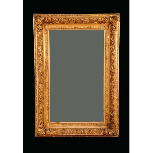 1467 - A 19th century giltwood and gesso rectangular looking glass, the bold frame moulded and applied with... 