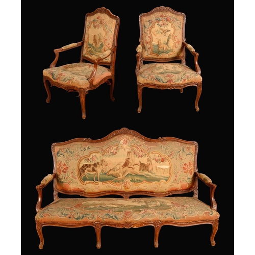 1472 - A Louis XV Revival three piece suite, comprising a sofa and a pair of armchairs, carved throughout w... 