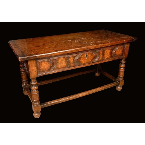 1476 - An 18th century Continental walnut serving table, probably Spanish, oversailing top above a shaped p... 